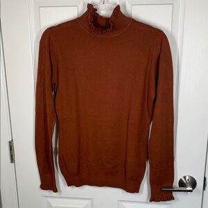 On twelfth rust colored ruffle hem turtleneck size XL